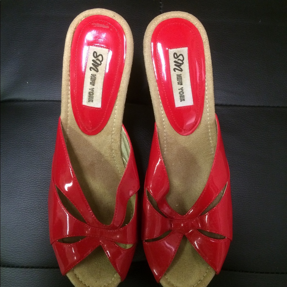 Patent leather red wedge sandals.